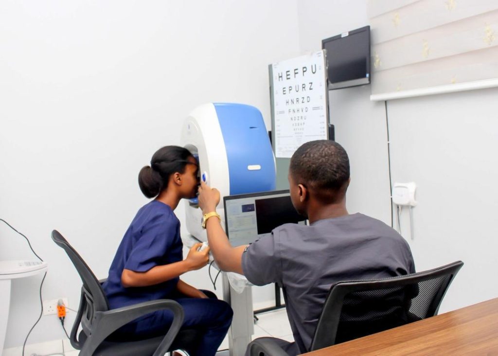 Optometrist performing an eye exam for a patient with cataracts.