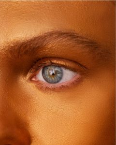 Close-up of an eye with a drop of artificial tears.