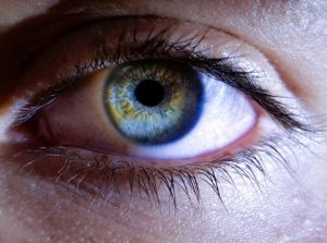 Close-up of an eye with a drop of artificial tears.