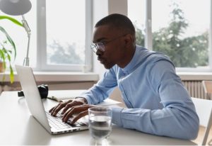 Person wearing computer glasses taking a break from working on a computer.