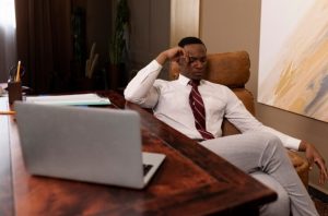 Person wearing computer glasses taking a break from working on a computer.