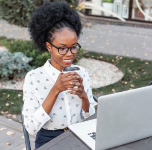 Person wearing computer glasses taking a break from working on a computer.