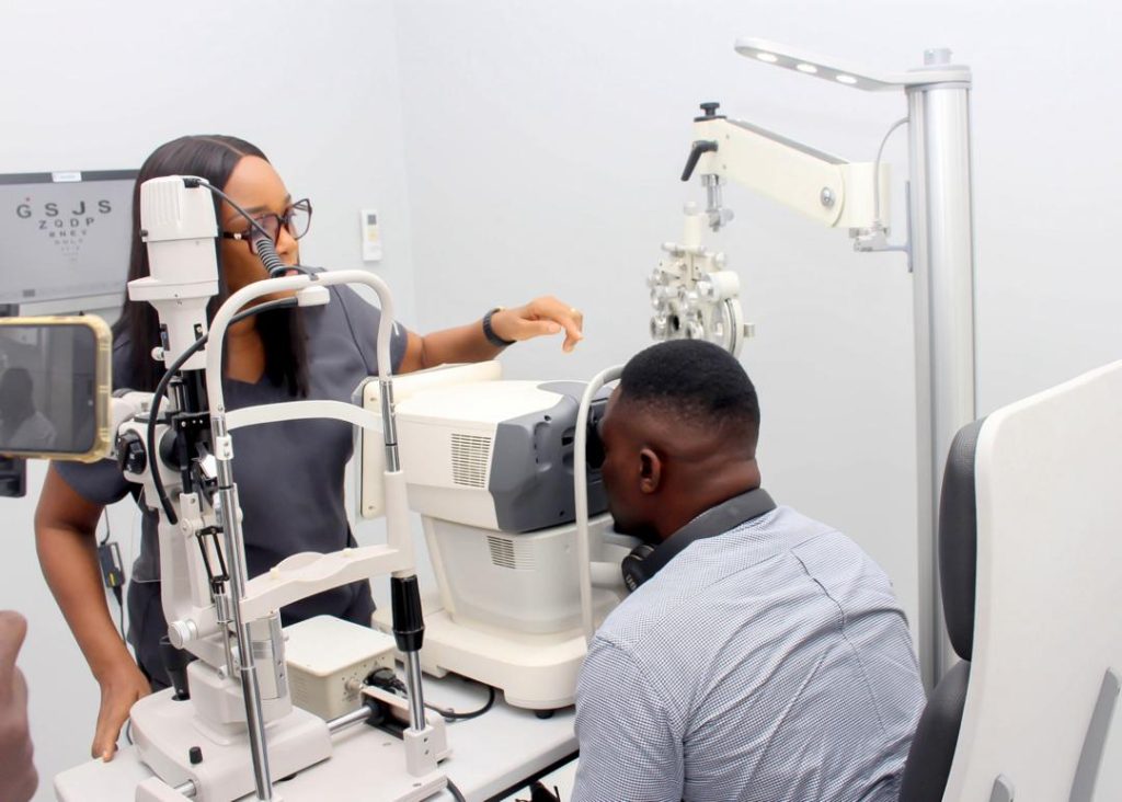 Optometrist performing an eye exam for a patient with cataracts.