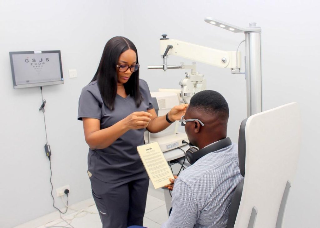 Optometrist discussing treatment options for eye pain and headaches with a patient.