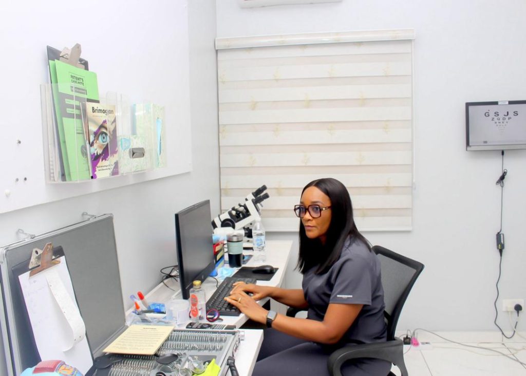 Optometrist examining a patient for dry eyes with a slit lamp